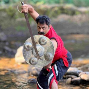 A practitioner practicing with traditional weapons in authentic Kalaripayattu.